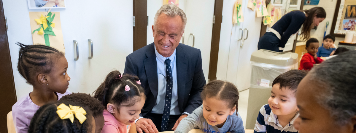 Photo of Secretary Kennedy playing with kids